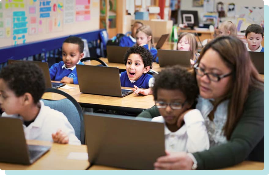 A student seated in a classroom expresses excitement
